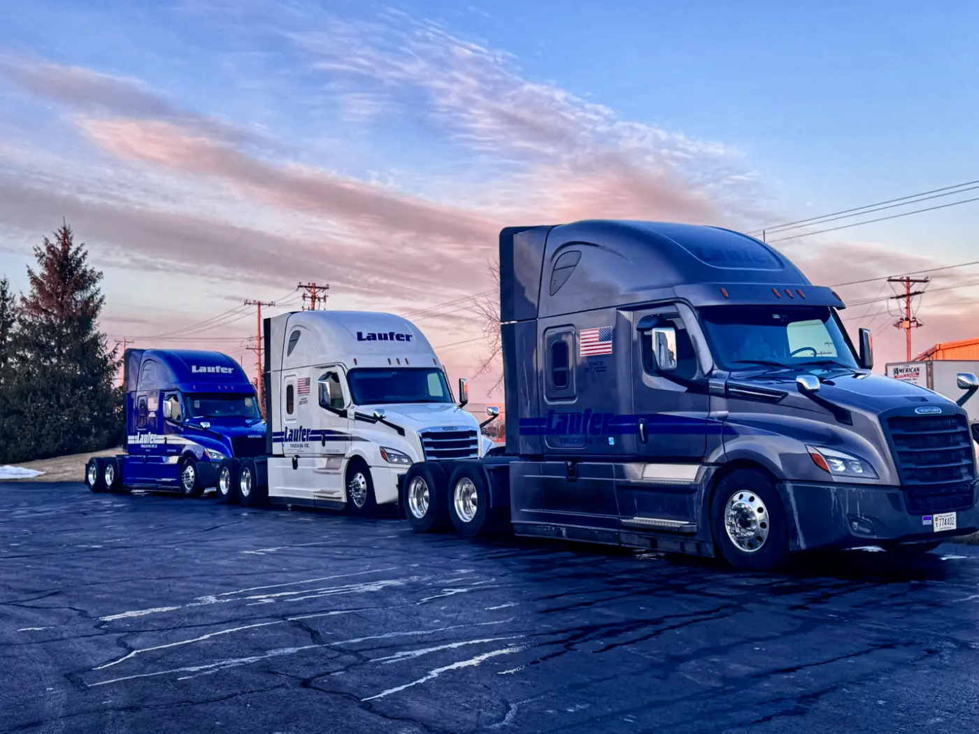 A Laufer Trucking semi-truck running empty on a Wisconsin highway between loads.