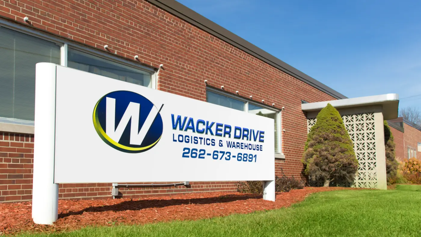 Wacker Drive Logistics & Warehouse monument sign in front of a brick facility for Laufer Trucking warehousing services.
